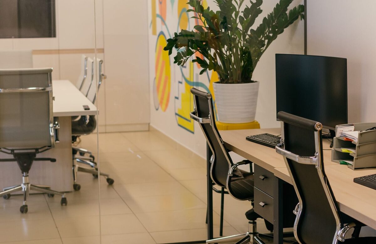 Bright, spotless modern office interior with glass partitions kept clean by ACC Services